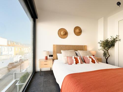 a bedroom with a large bed and a large window at Villa Poseidon Grupo AC Gestion in Zahara de los Atunes