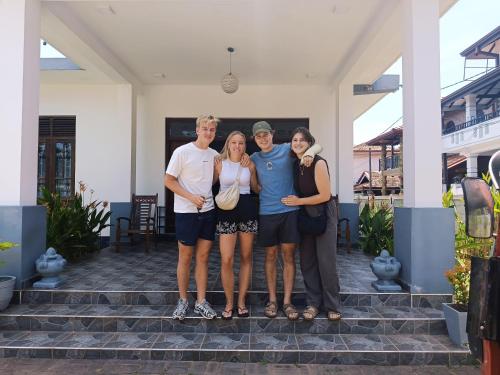 a group of people standing on the steps of a house at Negombo Signature Villa in Negombo