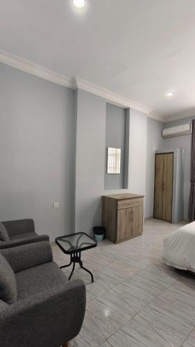 a living room with a couch and a bed at Villa Dalia Puncak CCC9-26 in Cikujang
