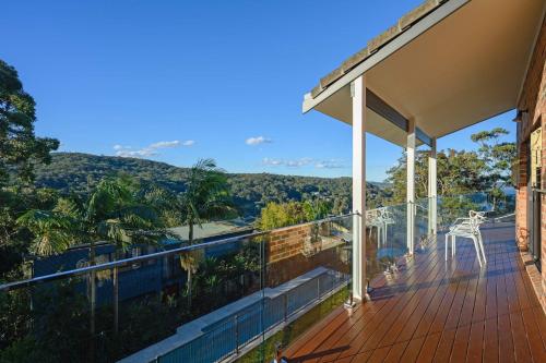 a balcony of a house with a view of the mountains at Stunning 4BR Home with Pool & Water Views in Koolewong