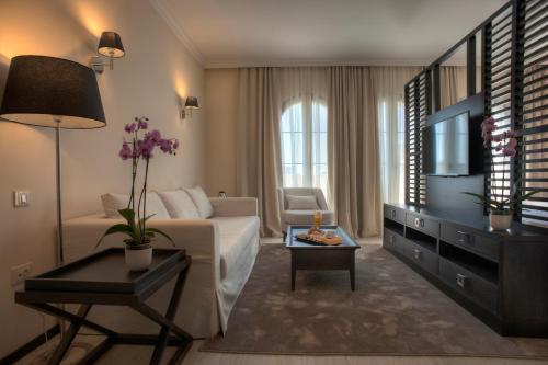 een woonkamer met een bank en een tv bij Hotel Moskva in Budva