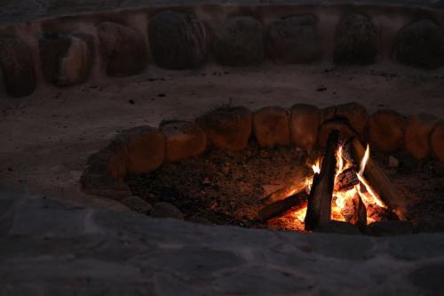 a brick oven with a fire in it at 10 stories hotel oze 尾瀬十帖 in Uonuma
