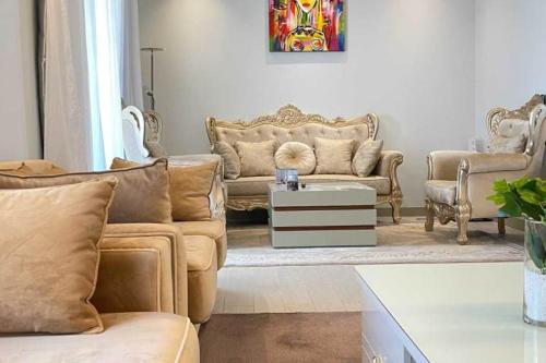 a living room with two couches and a table at Hôtel Ribadou Garoua in Garoua