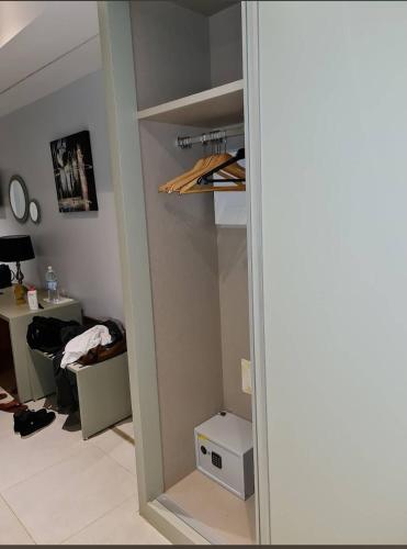 a room with a closet with a desk and a mirror at Hôtel Ribadou Garoua in Garoua
