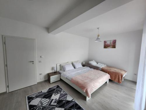 En eller flere senge i et værelse på Rine Apartment