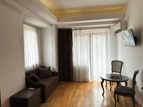 a living room with a couch and a table at Hillside Garden by Sienna in Skopje