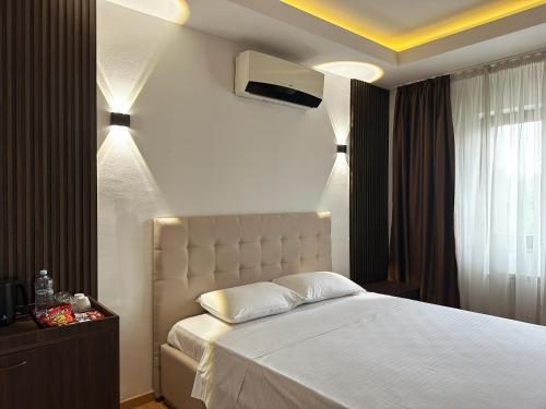a bedroom with a white bed and a window at Hillside Garden by Sienna in Skopje