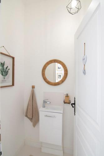 a bathroom with a sink and a mirror at Treize Maison B-2 bed house in centre of Saint Severin in Saint-Séverin