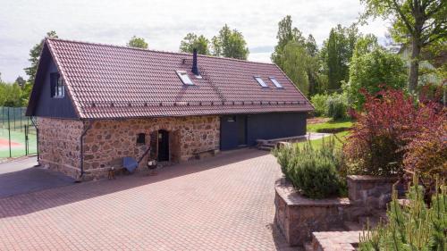 a small stone building with a red roof at Lättemaa in Raanitsa