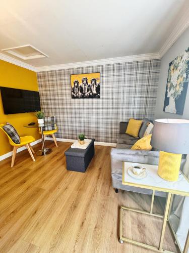 a living room with a couch and a table at Best Deal 1 Bed Apartment 5 minutes from Bedford in Bedford