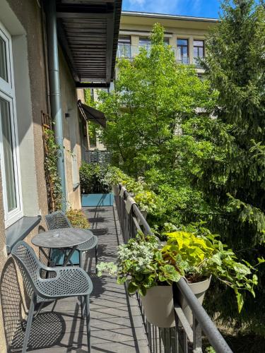 a patio with a table and chairs and plants at Moja Apartments Krakow Old Town in Krakow