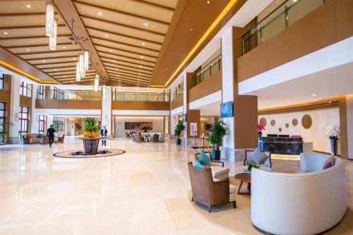 a lobby of a hospital with couches and chairs at Sanya Haitang Bay Health Valley Resort Hotel in Sanya