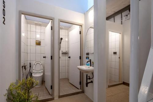 a bathroom with a toilet and a sink at MornSamyan in Bang Rak