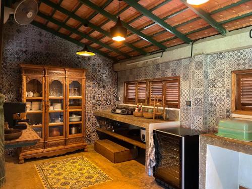 a kitchen with wooden cabinets and a counter top at Mlis Kampot River in Kampot
