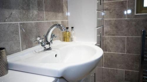 a white sink in a bathroom with a shower at Modern 1-Bedroom Apartment in Holt in Holt