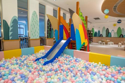 a large ball pit in a library with a slide at Sanya Haitang Bay Health Valley Resort Hotel in Sanya
