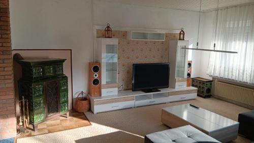 a living room with a flat screen tv and a couch at Ferienhaus Strandlöper Reiners in Horumersiel