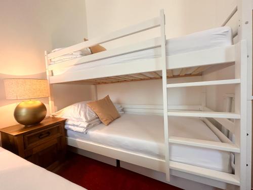 a bedroom with two bunk beds and a desk at Vila Černý leknín in Tábor