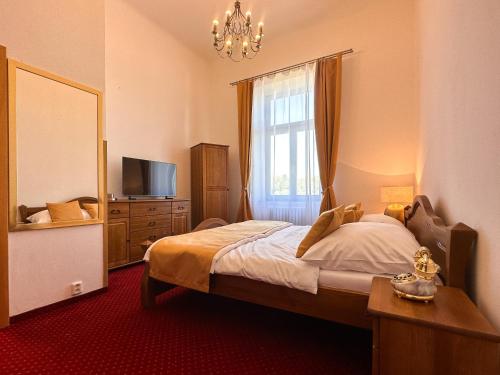 a bedroom with a bed and a mirror and a window at Vila Černý leknín in Tábor