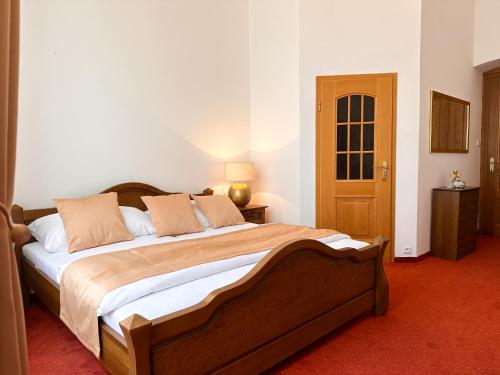 a bedroom with a large bed in a room at Vila Černý leknín in Tábor