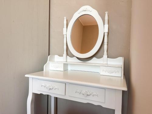 a white dressing table with a mirror on it at Vila Černý leknín in Tábor