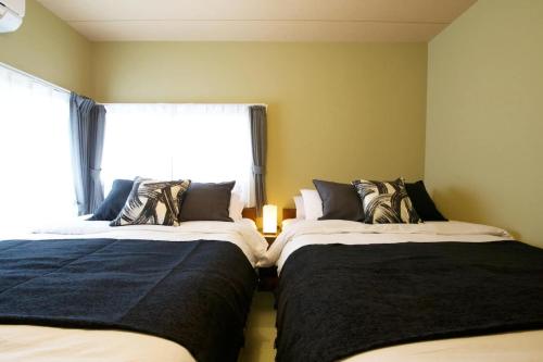 En eller flere senge i et værelse på Realization INN Horikiri