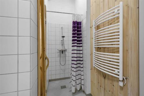a shower with a rack of wine bottles in a bathroom at 1431-Aakirkeby-Strandvangen-13-B in Vester Sømarken