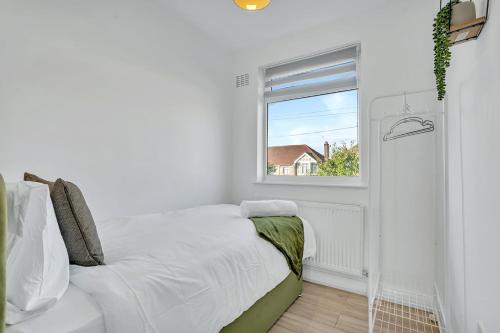 a white bedroom with a bed and a window at 7 Beds, 4 Bedrooms, Parking, Close to Station in Parkside
