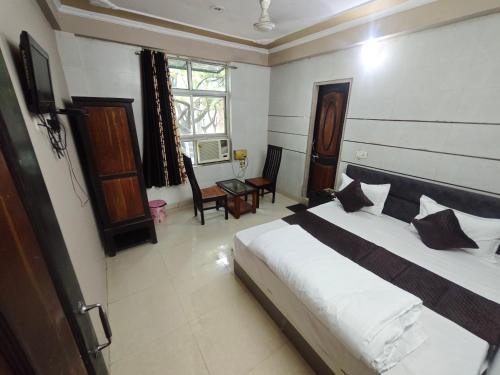 a bedroom with a bed and a table in it at Hotel Surya Palace in Chaumu
