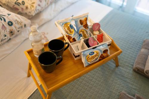 a small table with food and drinks on a bed at Altopiano Rooms Suite in Foggia