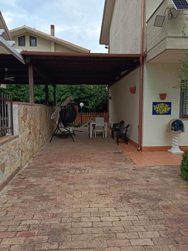 an outdoor patio with awning on a house at Villa Flora in Paestum