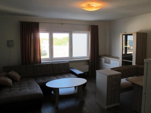 a living room with a couch and a table at Orissaare Apartment in Orissaare