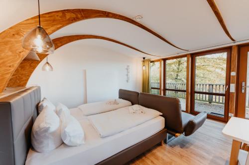 a living room with a white couch and windows at Sonnenresort Ettershaus in Bad Harzburg