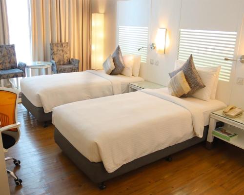 a hotel room with two beds in a room at Holiday Villa Hotel & Residence City Centre Doha in Doha