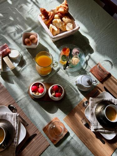 a table with breakfast foods and drinks on it at Le Mas de la Prade in Bages