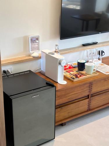 a desk with a television and a machine on it at 屋子旅店 in Puli