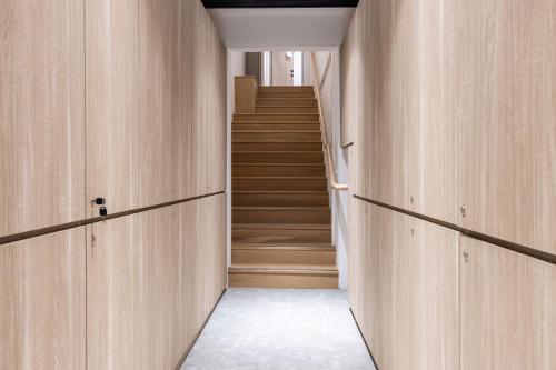 a hallway with wooden walls and stairs in a house at Heritage Collection on Victoria - Mobile App Check-In in Singapore