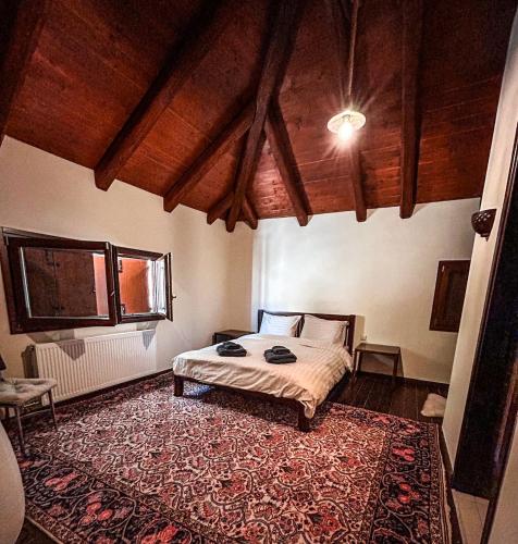 a bedroom with a bed and a large rug at Veranda Villa in Arachova