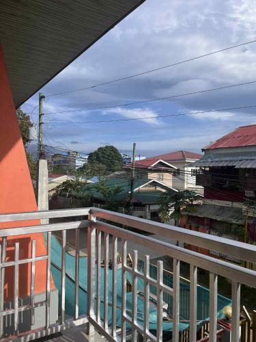 a balcony of a house with a view of a pool at Ace Transient in Puerto Princesa City