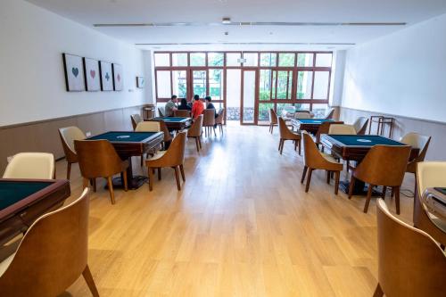 a restaurant with tables and chairs and people sitting at tables at Sanya Haitang Bay Health Valley Resort Hotel in Sanya