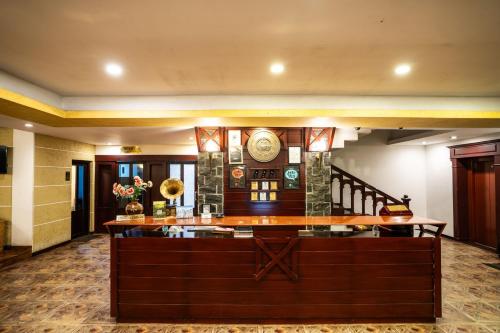 a lobby of a hotel with a bar and a staircase at Hotel C7 Munnar in Munnar