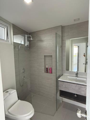 a bathroom with a toilet and a sink and a shower at BEACH Condo Mae Phim in Ban Tha Fat