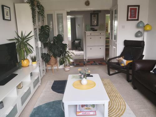 a living room with a couch and a table at The Peak Retreat in Longdendale