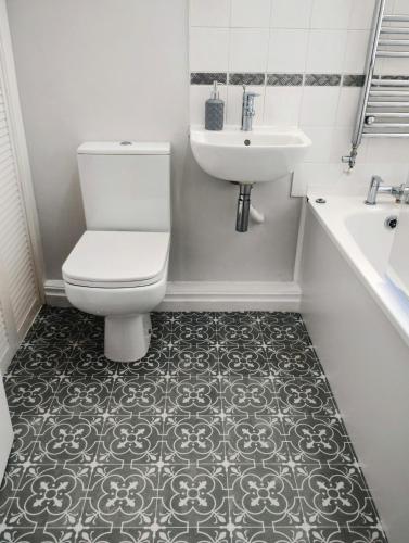 a bathroom with a toilet and a sink at The Peak Retreat in Longdendale