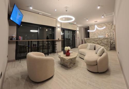 a living room with two chairs and a bar at Hotel Aquarius Dubrovnik in Dubrovnik