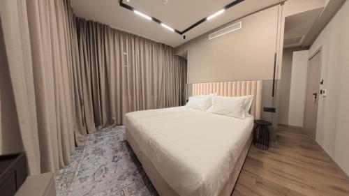 a bedroom with a white bed in a room at Hotel Aquarius Dubrovnik in Dubrovnik