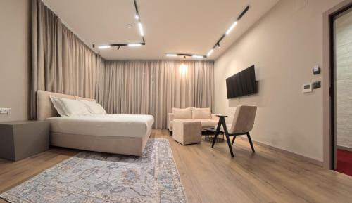 a bedroom with a bed and a table and a chair at Hotel Aquarius Dubrovnik in Dubrovnik