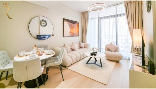 a living room with a couch and a table at Comfort Cove 1BR- 2 Minutes Walk to Al Maryah Fireworks in Abu Dhabi