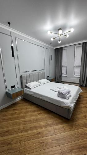 a bedroom with a bed and a ceiling fan at 2 room apartment, ЖК Кристалл in Almaty