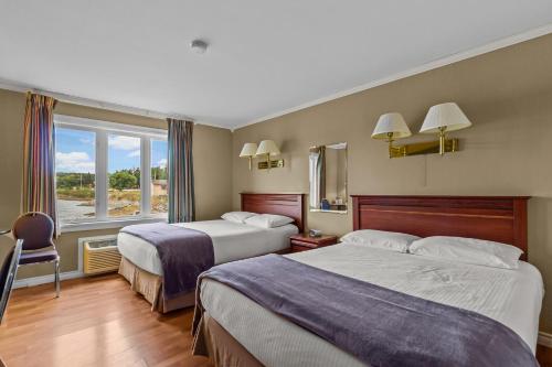 a hotel room with two beds and a window at Bayview Inn in Bay Roberts